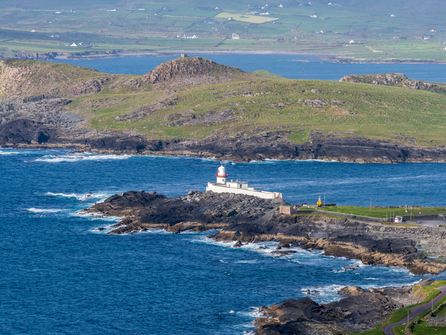 Lighthouse along rugged coastline in Valentia, Kerry.
