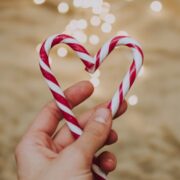 Hand holding candy heart.