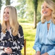 Two women sitting in a garden.