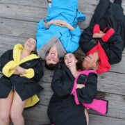 Young people wearing Salt Robe swim robes.
