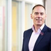 Man in navy sports jacket.