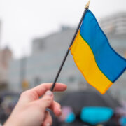 Hand holds Ukraine flag.