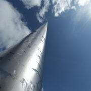 Spire in Dublin reaching a blue sky with clouds.