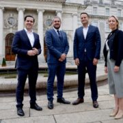 Three men and a woman outside Government buildings in Dublin.