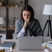 Unwell employee at her desk.