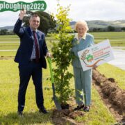 Man and woman in a big field for the ploughing.