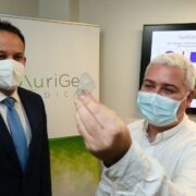 Two men looking at a medical heart implant.