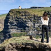 Woman standing on cliff.