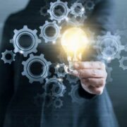 Woman innovator holding lightbulb.