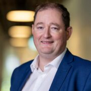 Man in navy blue suit.