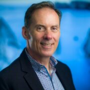 Man in navy sports jacket.