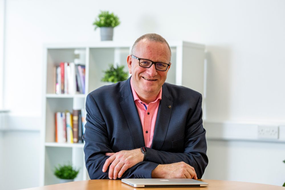 Smiling man in blazer.
