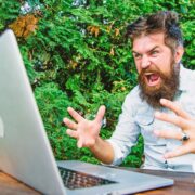 Angry employee with a laptop.