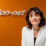 Woman in white coat.