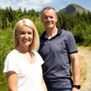 Man and woman walking in mountains.