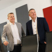 Two men dressed in smart casual.