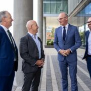 Four men in suits talking.