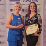 Two women holding awards.