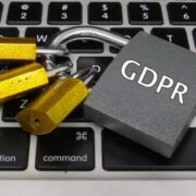 Padlock with words GDPR sitting on a keyboard.