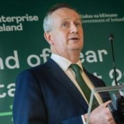man in green tie making a speech.