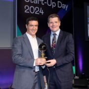 Men in suits holding an award.