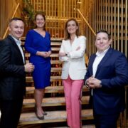Two men and two woman standing on a stairs.