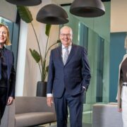 Two women and a man in business atire.