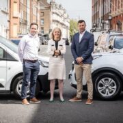 Two men and a woman stand on a street in Dublin.