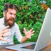 Frustrated worker yelling at computer.