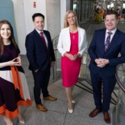 Two men and two women in business atire.