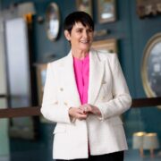 Woman wearing white jacket.