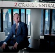 Man in blue suit in an office in Manhattan.