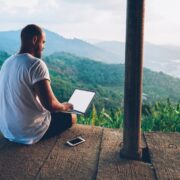 Man working remotely from a tropical location.
