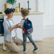 Woman sending her son to school.