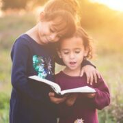 Kids reading a book.