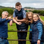 Farming family at farm gate.
