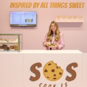 Woman behind the counter of a cookie shop.