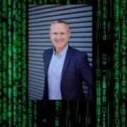 Man in navy jacket and blue shirt.