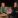 Two woman standing among whiskey barrels.