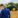 Farmers in a field in front of a tractor.