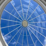 Blue sky through atrium glass.