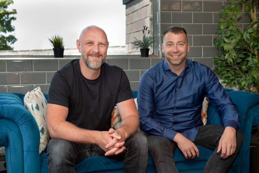 Two men sitting on a couch.