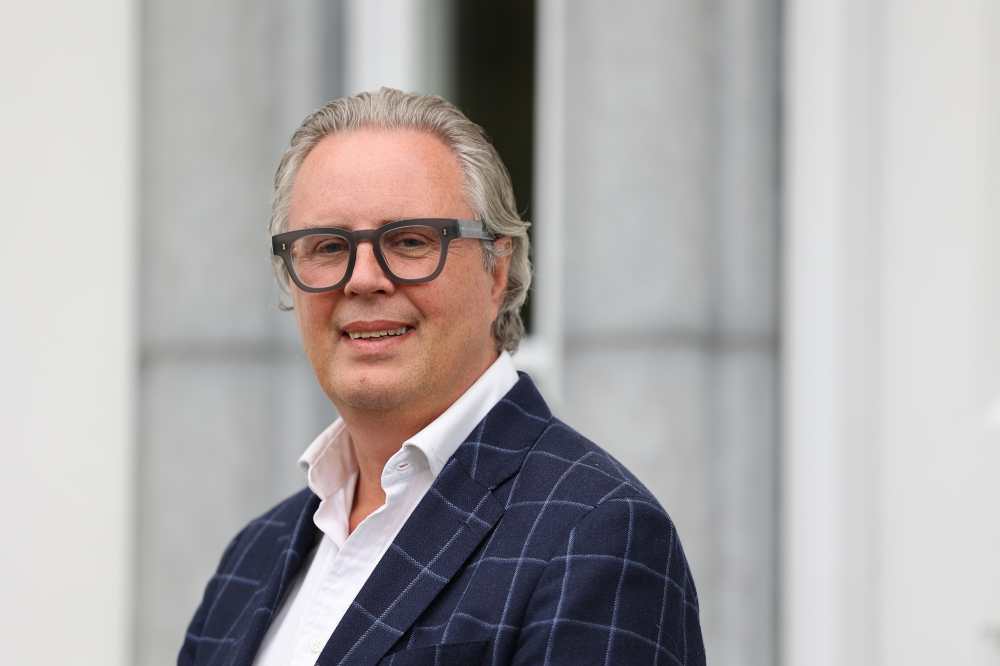 Man in suit and glasses.