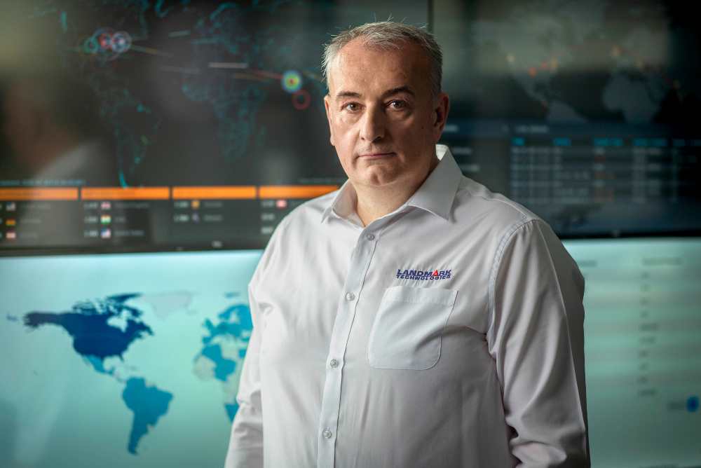 Man standing in cybersecurity control centre.