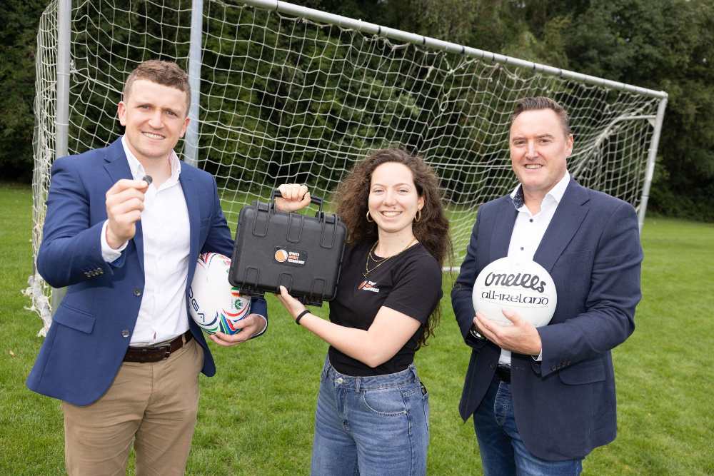 Two men and a woman demonstrating sports safety tech.