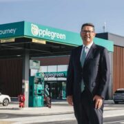 Man in suit standing on an Applegreen forecourt.