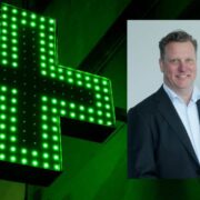 Man inset on image of pharmacy green cross light.
