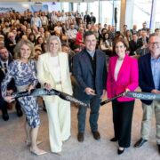Group of Datavant staff and invited guests gathered inside the Bonham Quay office in Galway, standing in front of a seated audience while cutting a branded Datavant ribbon to mark the opening of the company’s Global R&D Centre.