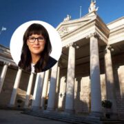 Close-up portrait overlay of a person in professional attire with glasses, set against the exterior of a grand neoclassical bank building with tall stone columns and ornate architectural detailing under a clear blue sky.